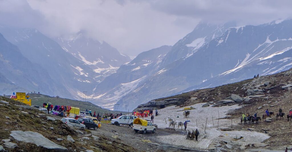 People Walking on Snow Covered Ground Near Mountains