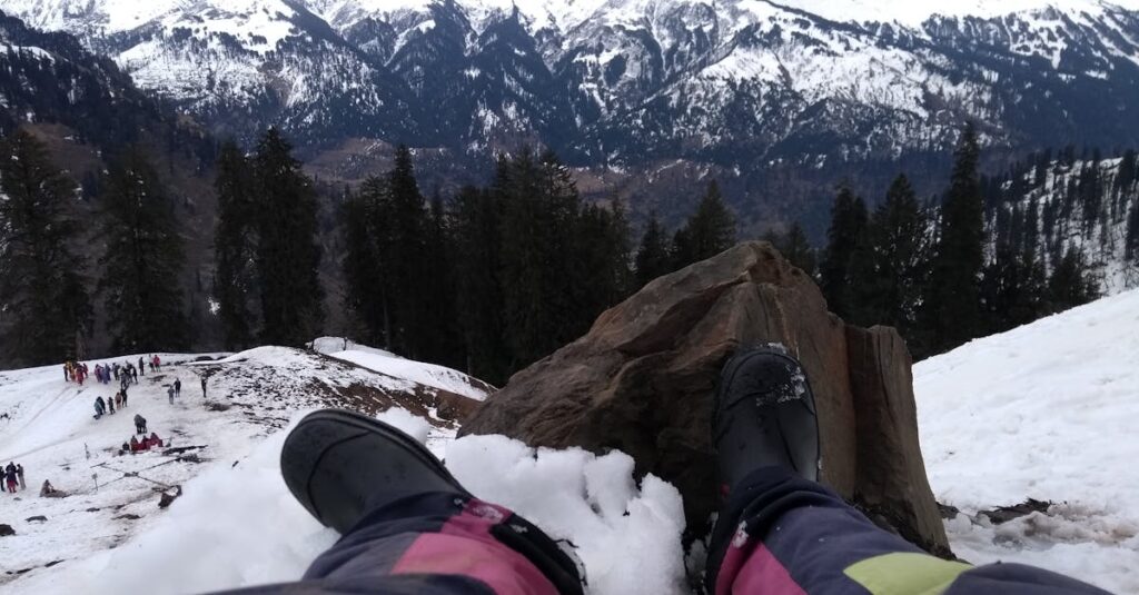 Person Wearing Black Boots At Snowy Mountain